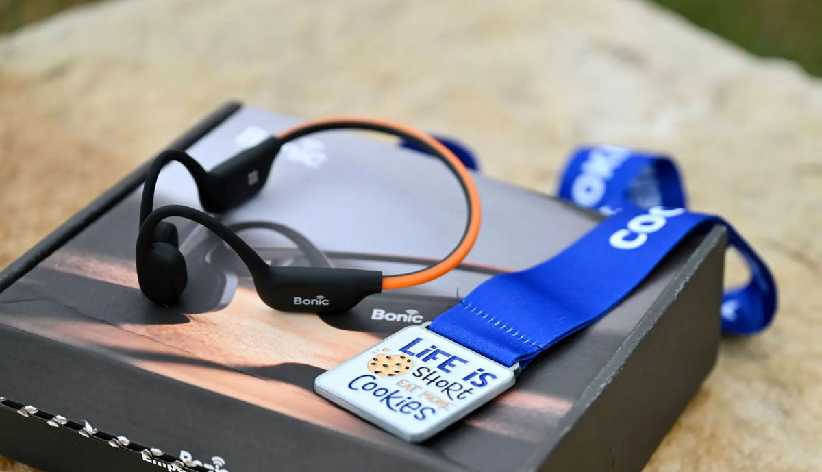 Open-ear sport headset on box for bone conduction vs open-ear headphones comparison.   